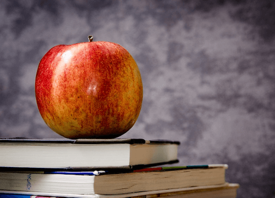 Apple sitting on a stack of books