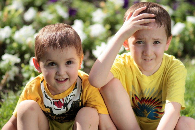 two young boys in yellow shirts