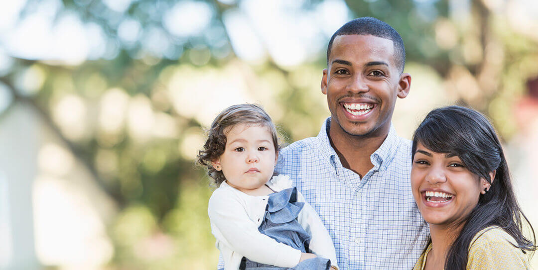 Young couple with baby smiling