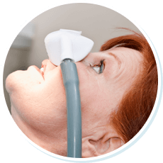 woman in dental chair receiving sedation