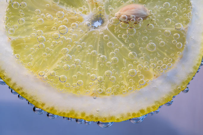 close up of slice of lemon in water