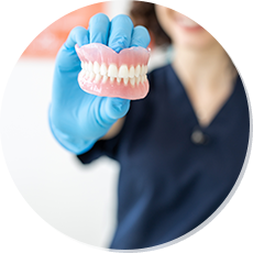 woman holding denture model