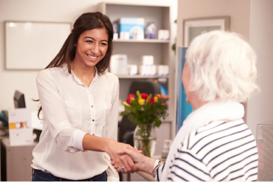 senior patient being greeted at the dentist office