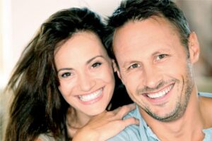 young couple smile showing off their teeth whitening treatments
