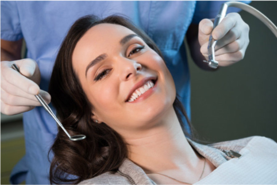 young woman smiles sitting in the dentist chair