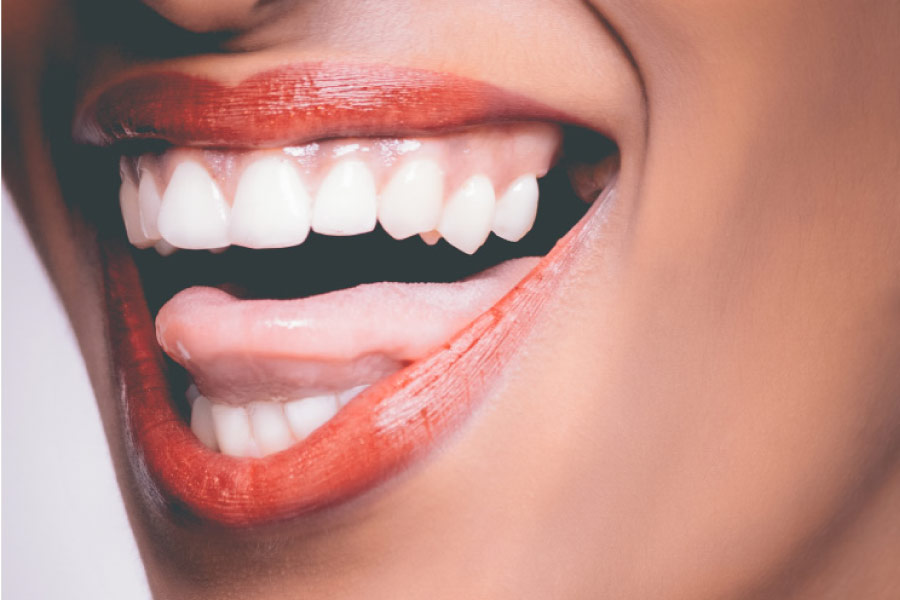 closeup of a woman's mouth open showing teeth and tongue