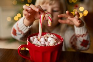 little girl drinking hot chocolate, kids and holiday treats prevent cavities