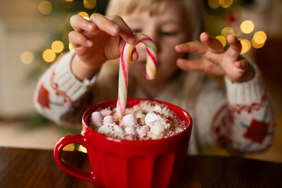 little girl drinking hot chocolate, kids and holiday treats prevent cavities