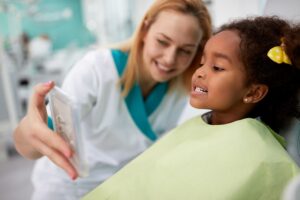 child at dentist developing early dental habits for National Children’s Dental Health Month