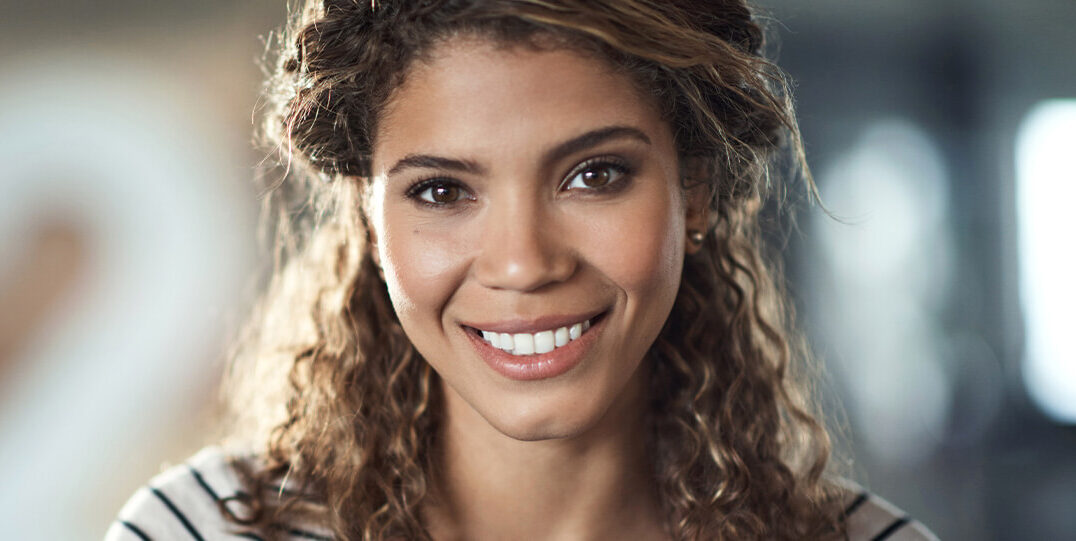 Woman leaning out of window smiling