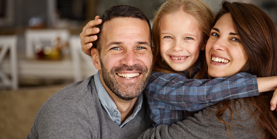 Parents and daughter smiling